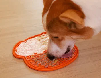 Dog using LickCalm lick mat slow feeder